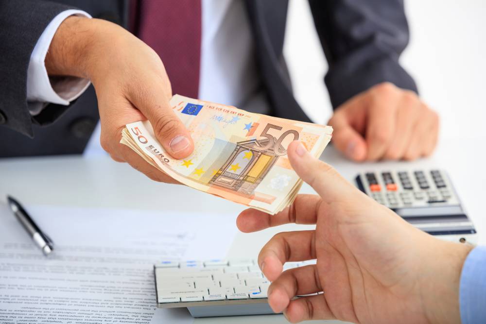 Man in suit receiving money